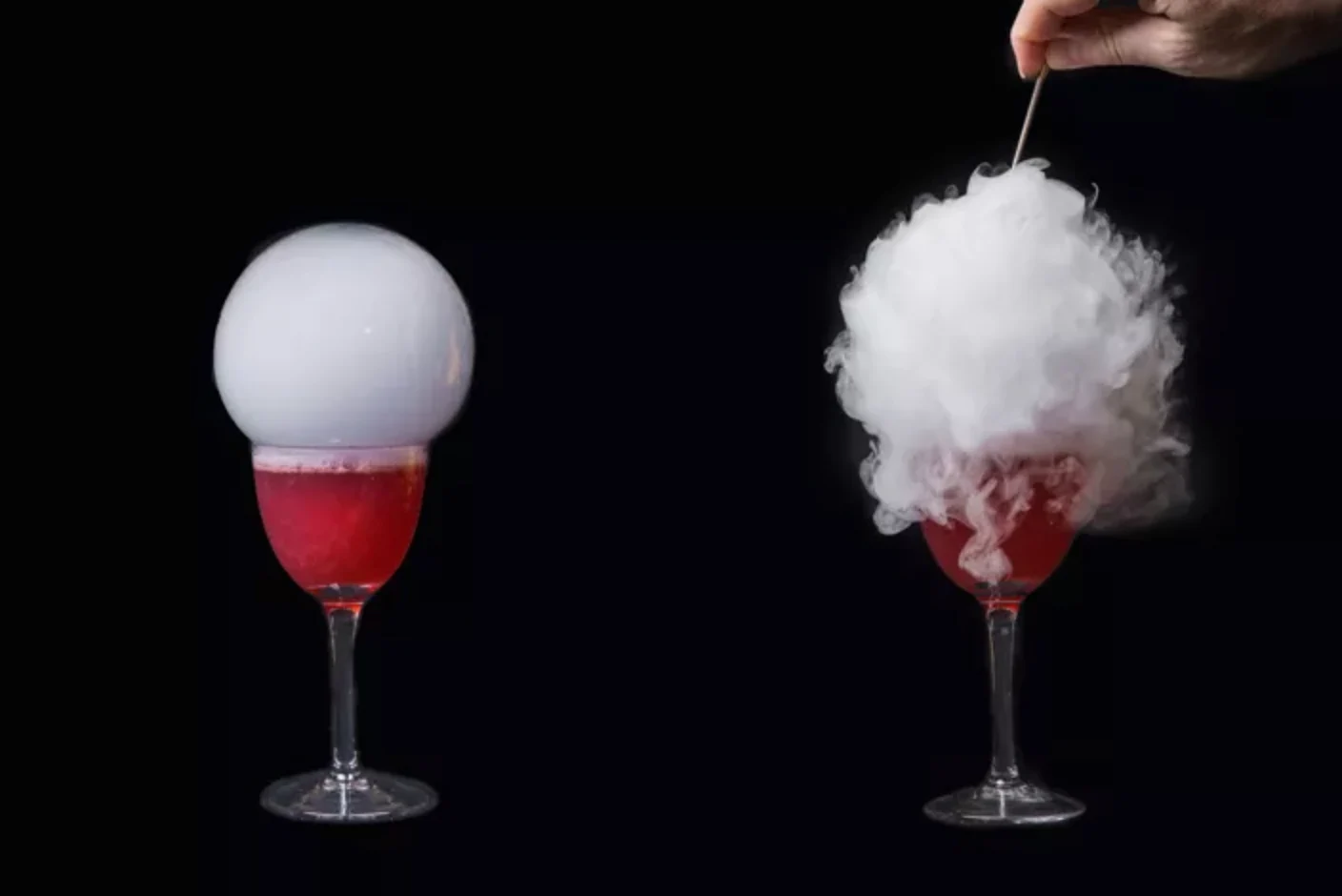 A cocktail topped with a delicate smoke-filled bubble, shown releasing a cloud of smoke
